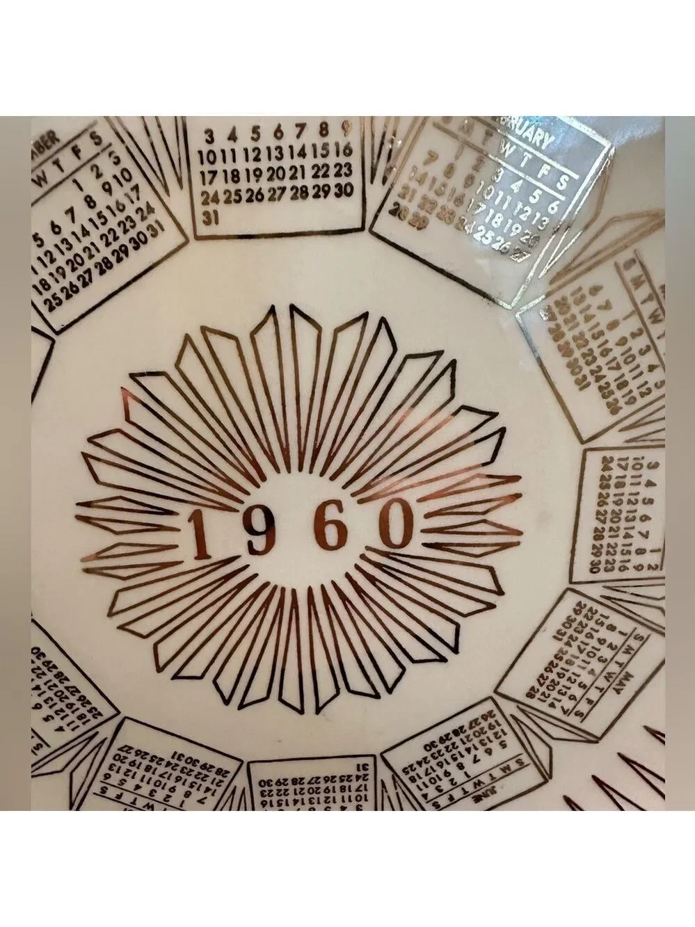 Vintage 1960 Calendar plate. Excellent shape. Wall hanger included. White + Gold